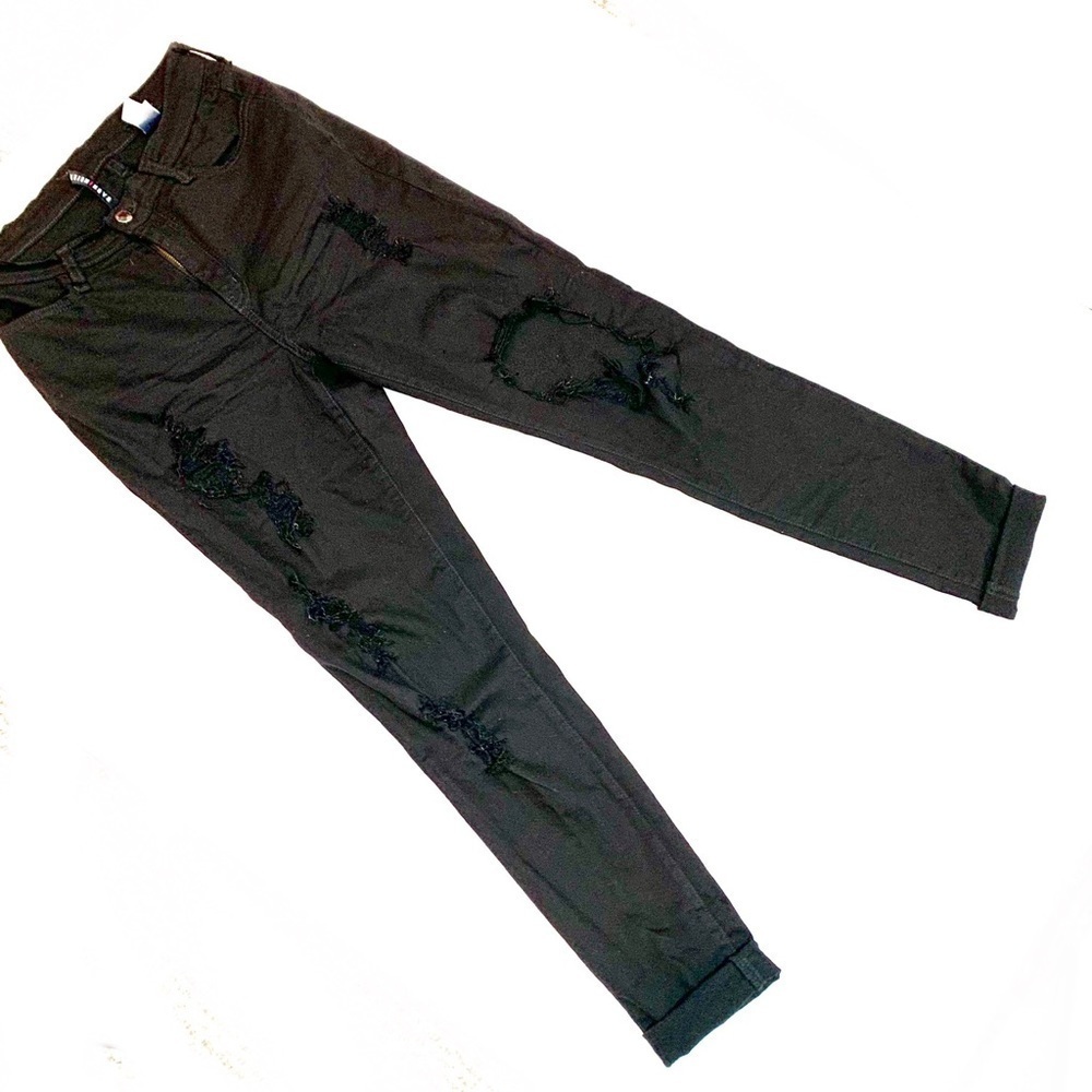 Tattered black skinny jeans